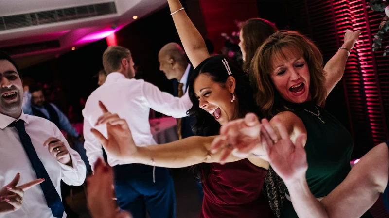 A wedding reception with a DJ playing must-have songs.